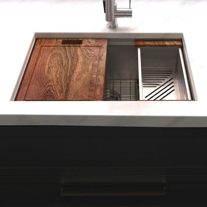 Single-bowl sink with dark wood cutting board and slotted rack accessory