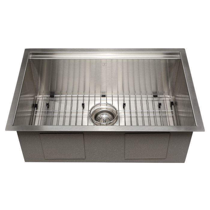 Stainless steel undermount sink interior with bottom grid and round drain strainer