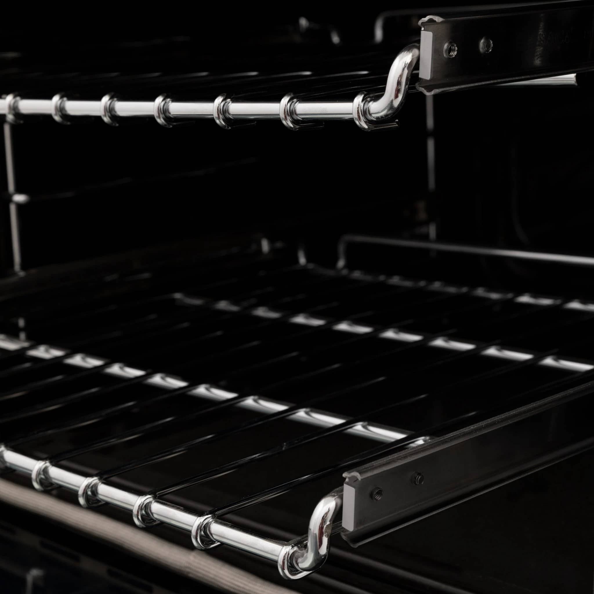 Dual fuel range cooktop grates with chrome burner rings and black enamel surface