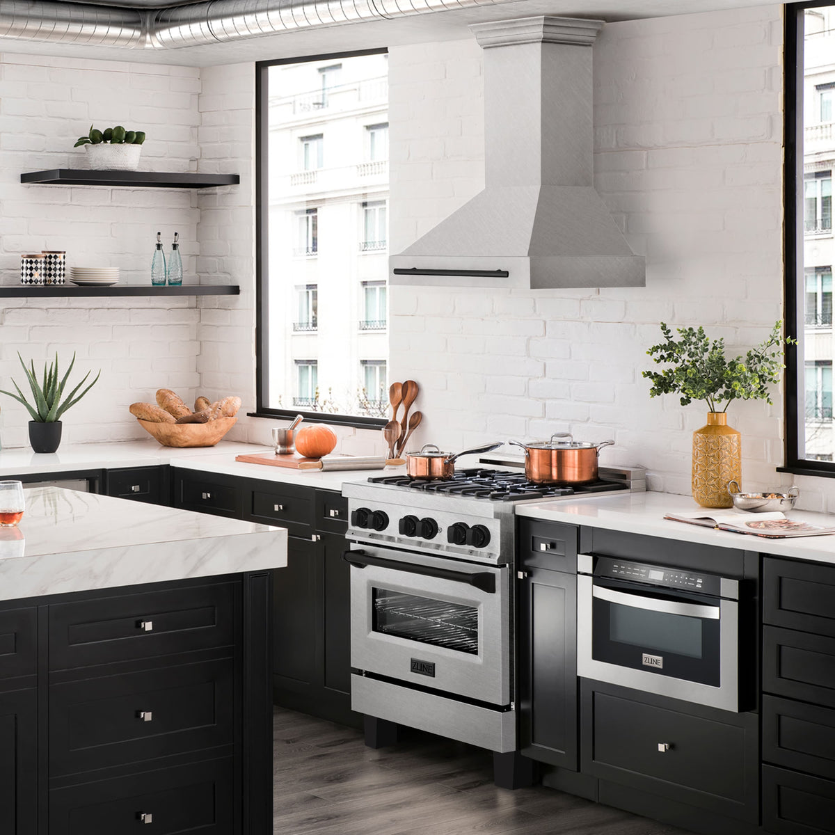 Wall mount range hood with satin stainless chimney and matte black handle in kitchen