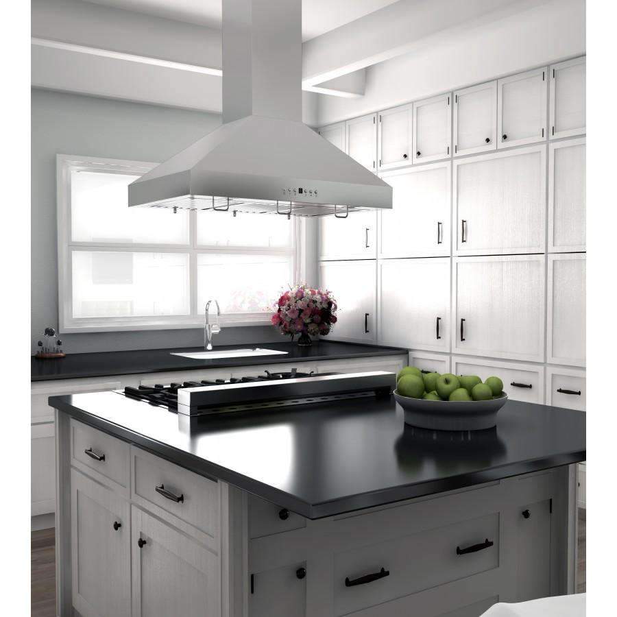 Stainless steel island mount range hood over black cooktop with hanging chimney