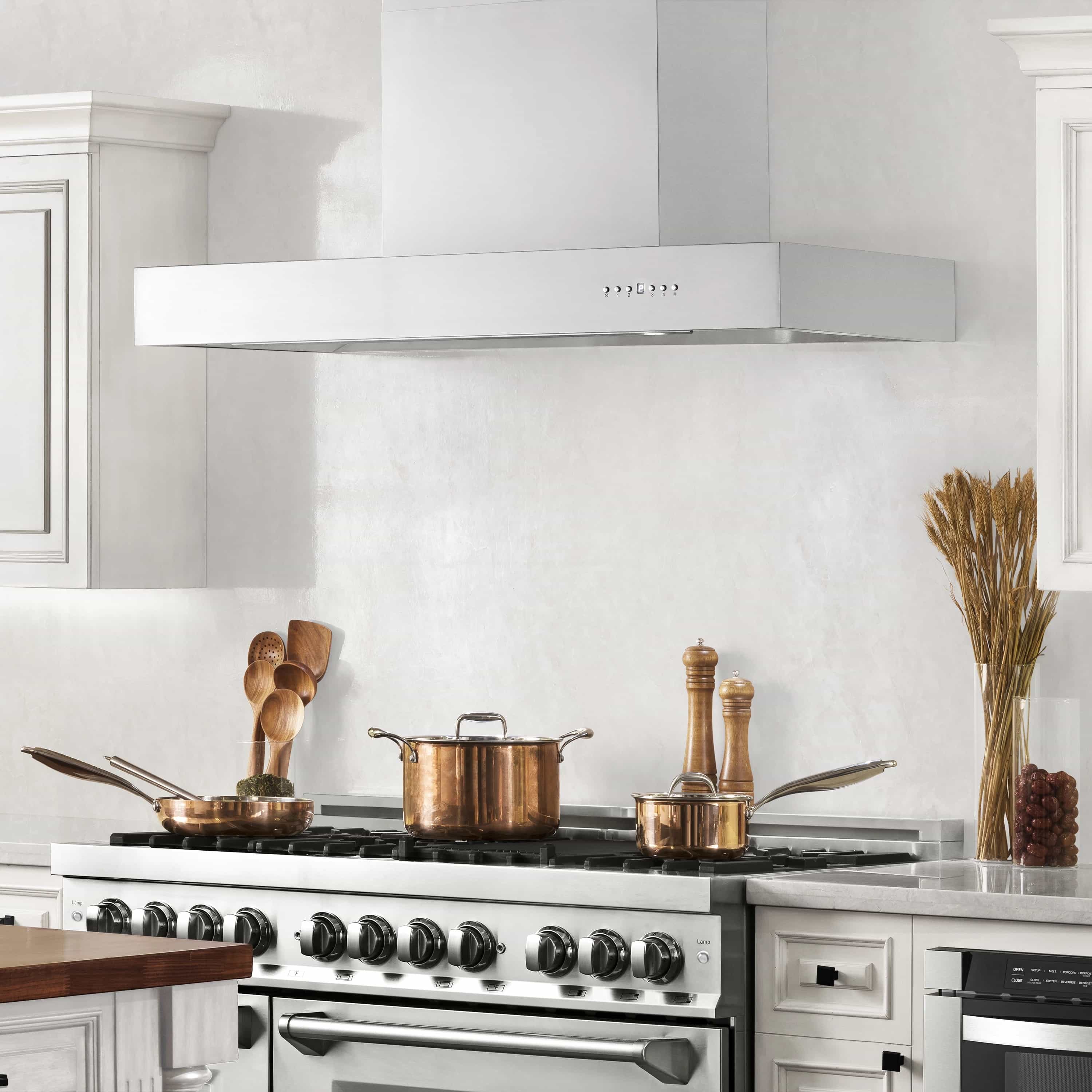 Stainless steel chimney range hood above a cooktop with button controls on the front