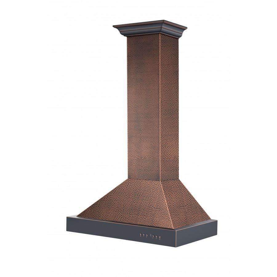 Wall range hood with hammered copper chimney and black chimney cap, wide curved canopy.