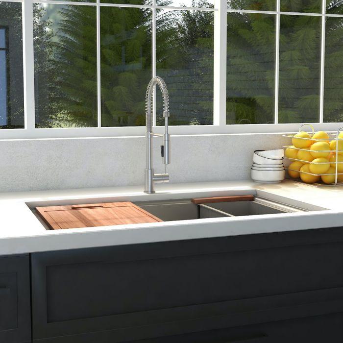 Single-bowl stainless steel kitchen sink with faucet and wood cutting board
