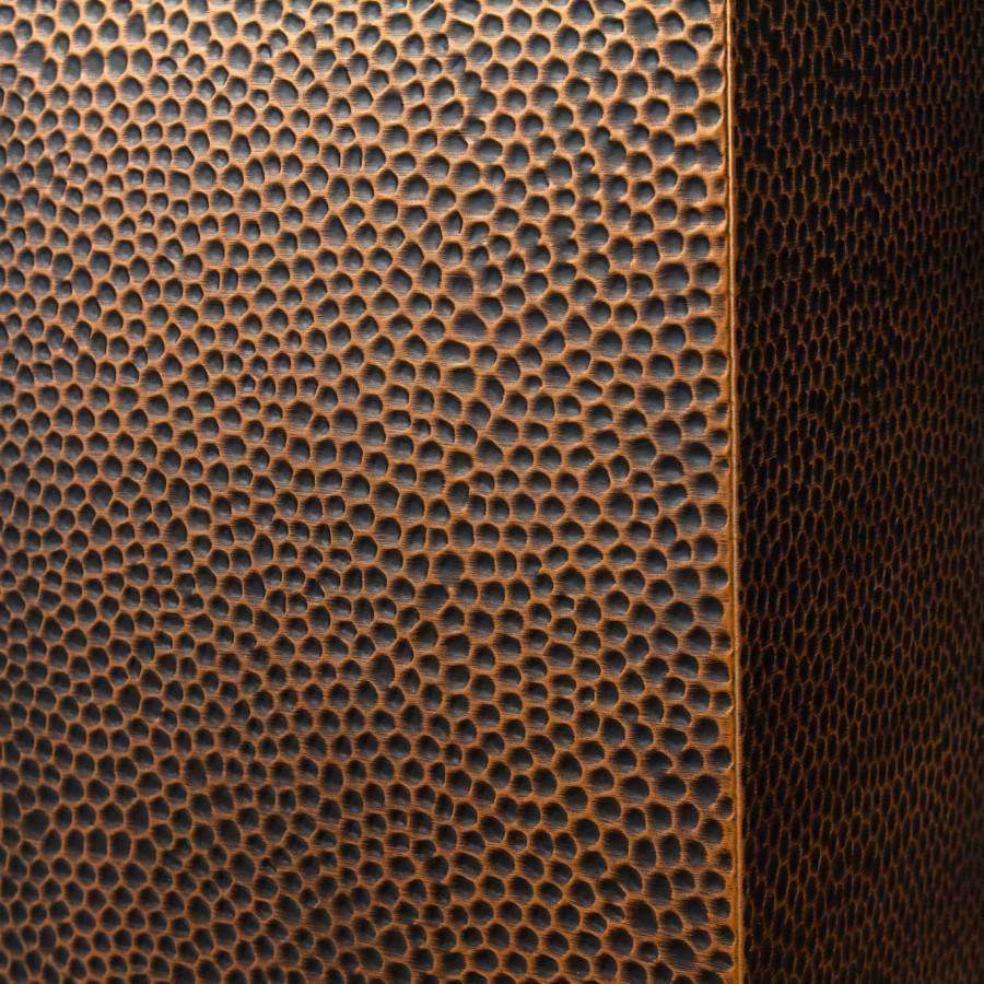 Hand-hammered copper finish with pebble-like texture on hood panel