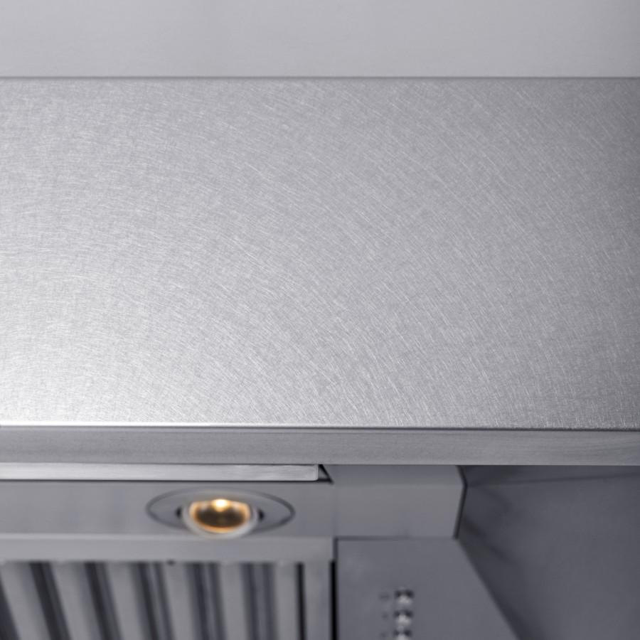 Close-up of under-cabinet range hood baffle filter and recessed light