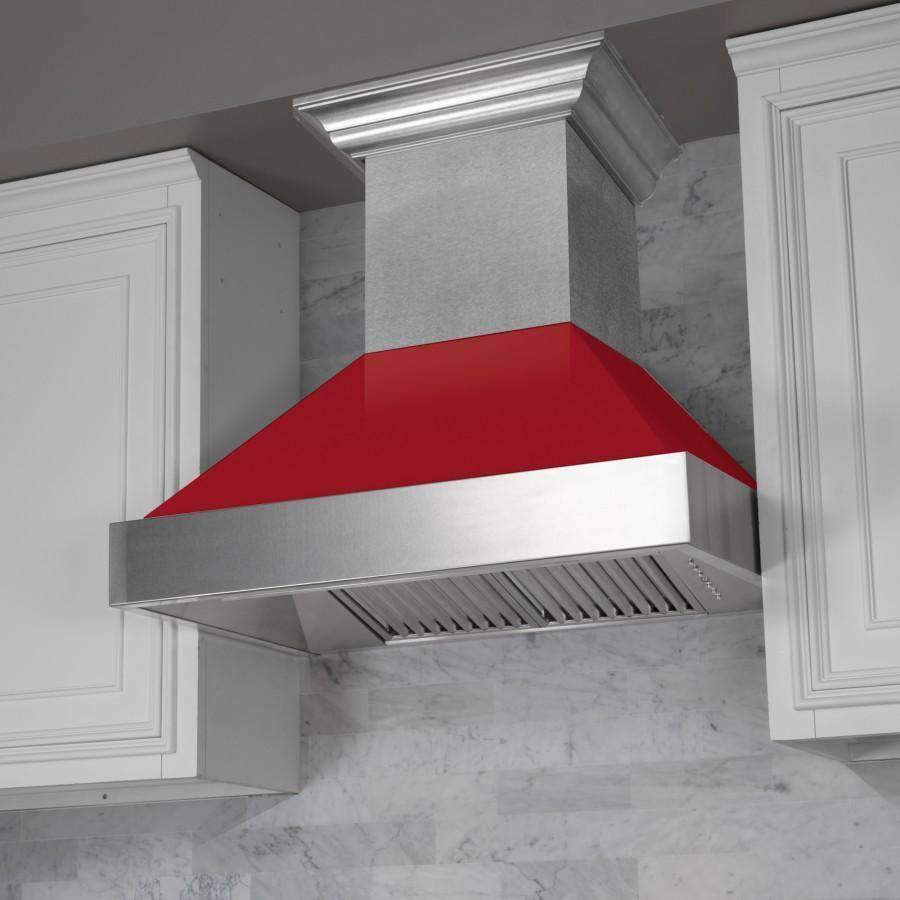 Stainless wall range hood with red gloss interior and vented canopy under white cabinets.