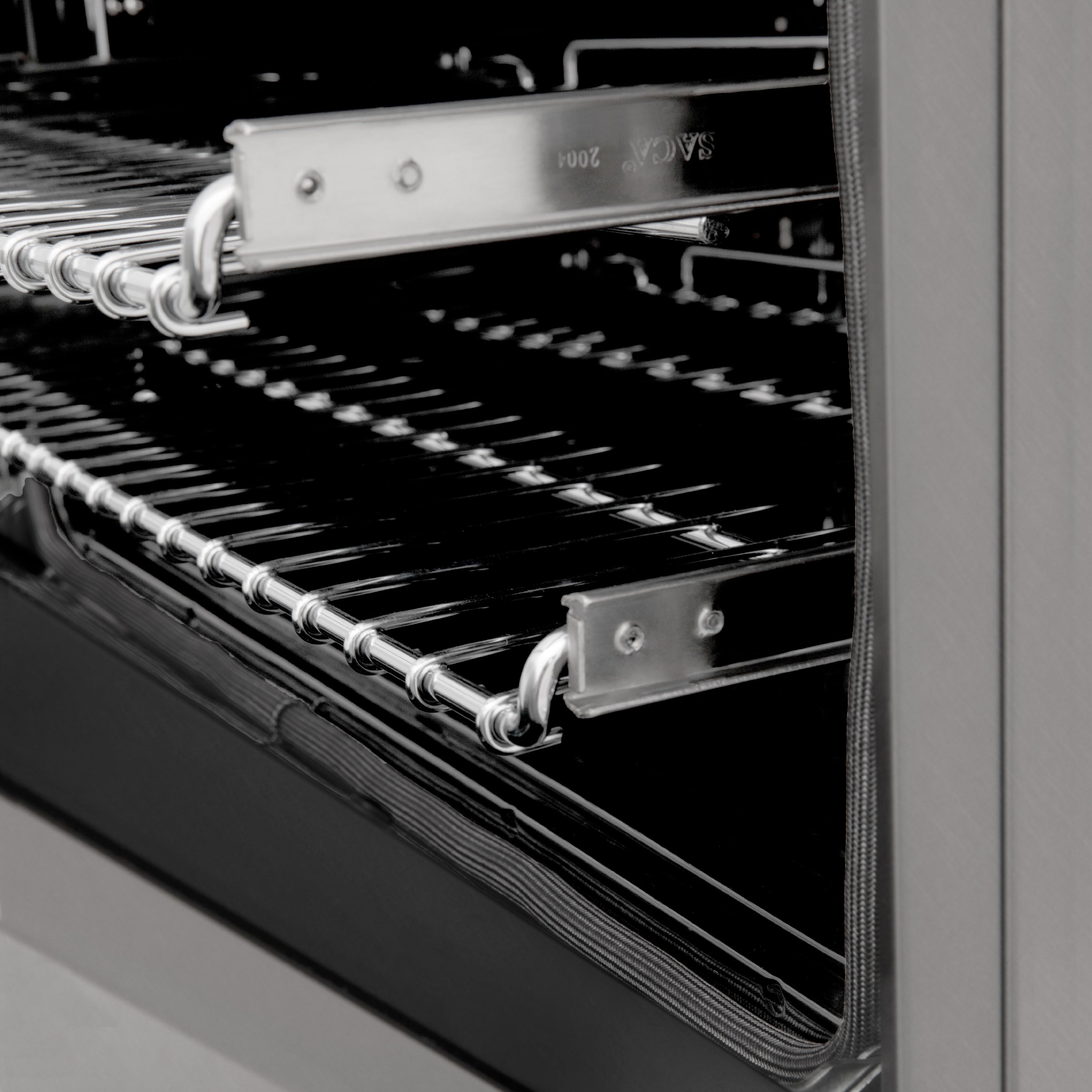 Satin stainless steel gas range with chrome grates, oven door open, control area visible