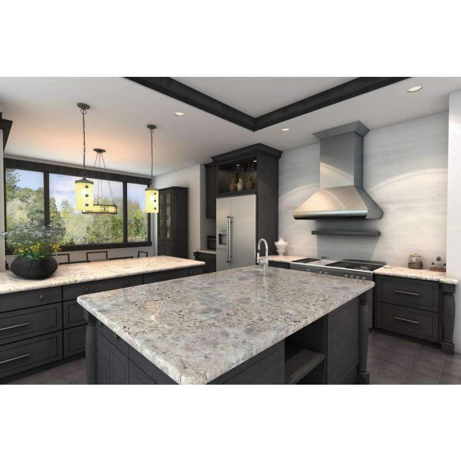 Stainless steel ducted wall mount range hood above a kitchen island cooktop