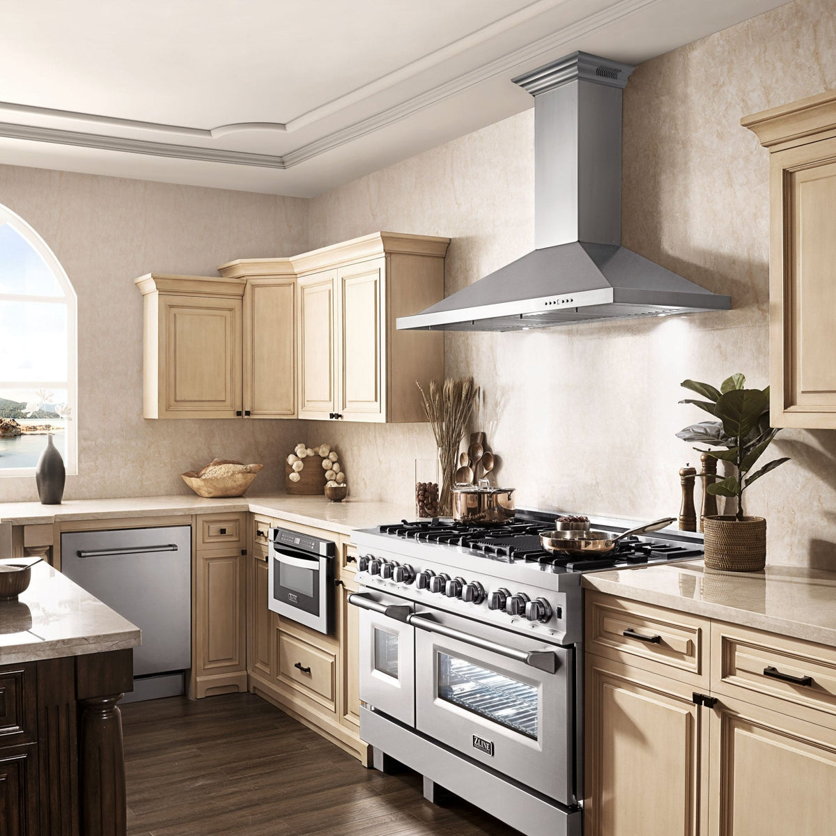 Stainless steel wall mount range hood above a gas cooktop