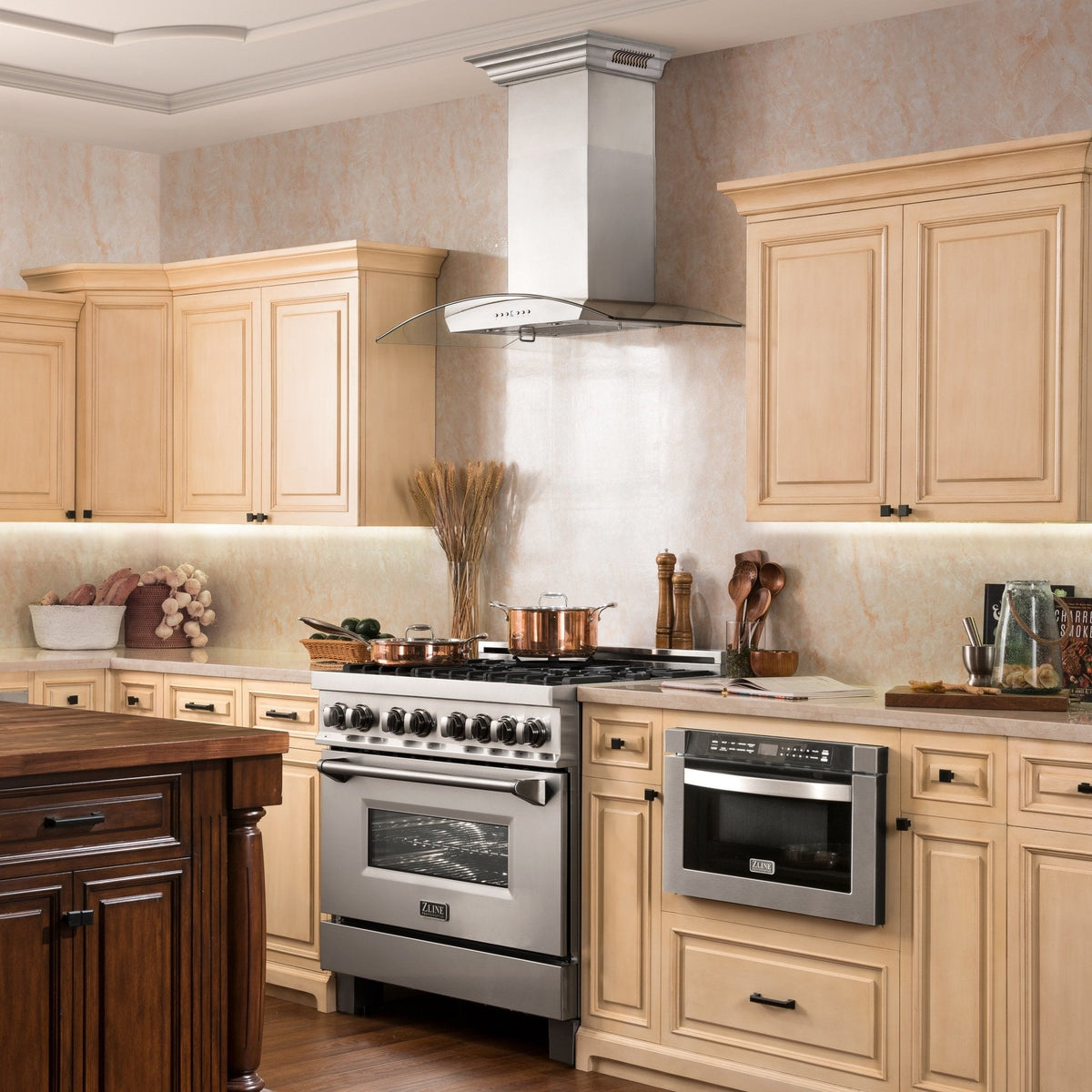 Stainless steel wall-mount range hood installed above a kitchen range, black cooktop behind