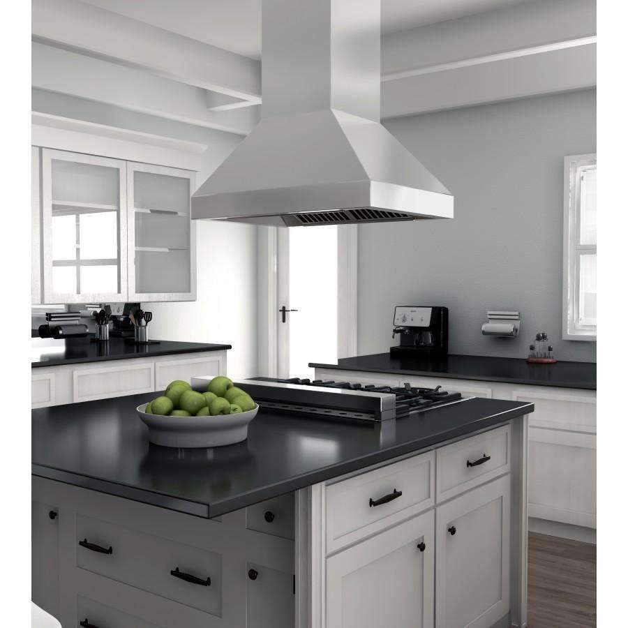 Stainless steel island range hood with dark vent grille over black cooktop