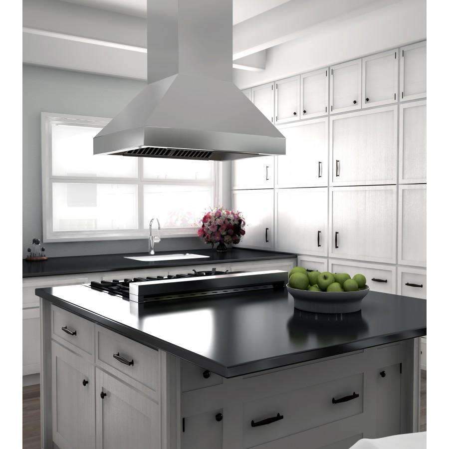 Stainless steel island range hood above a black kitchen island countertop