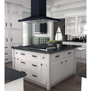 Black island range hood canopy with hanging filter box over a gas cooktop