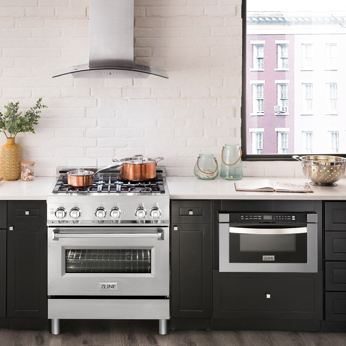 Stainless dual fuel range cooktop with burner grates and visible oven door.