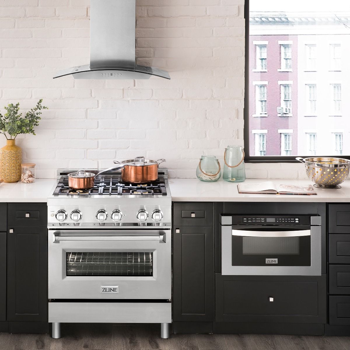 Stainless dual-fuel range with 4 gas burners and closed electric oven door, knob panel