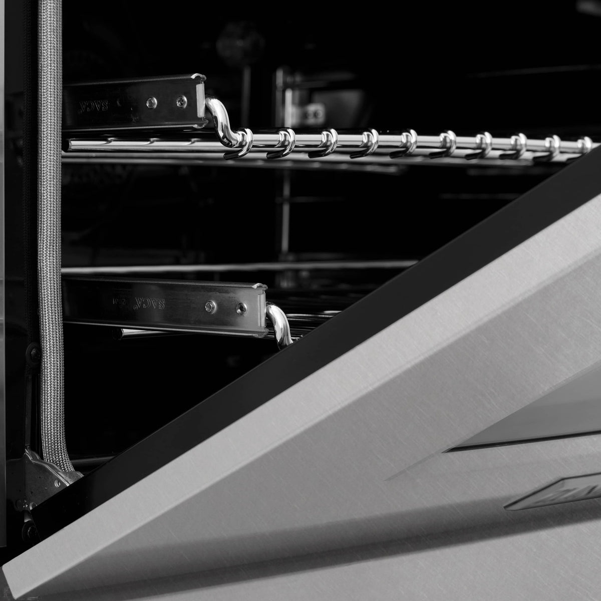 Dual fuel range oven interior with chrome racks and side rail hooks