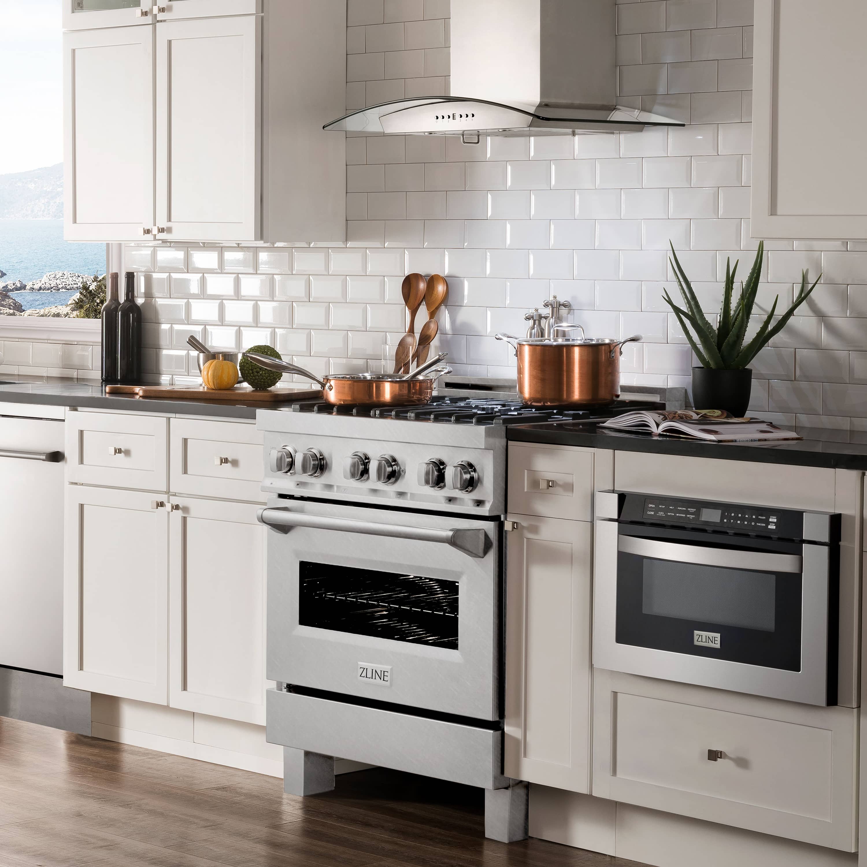 Dual fuel range in satin stainless steel with black cooktop grates and control knobs