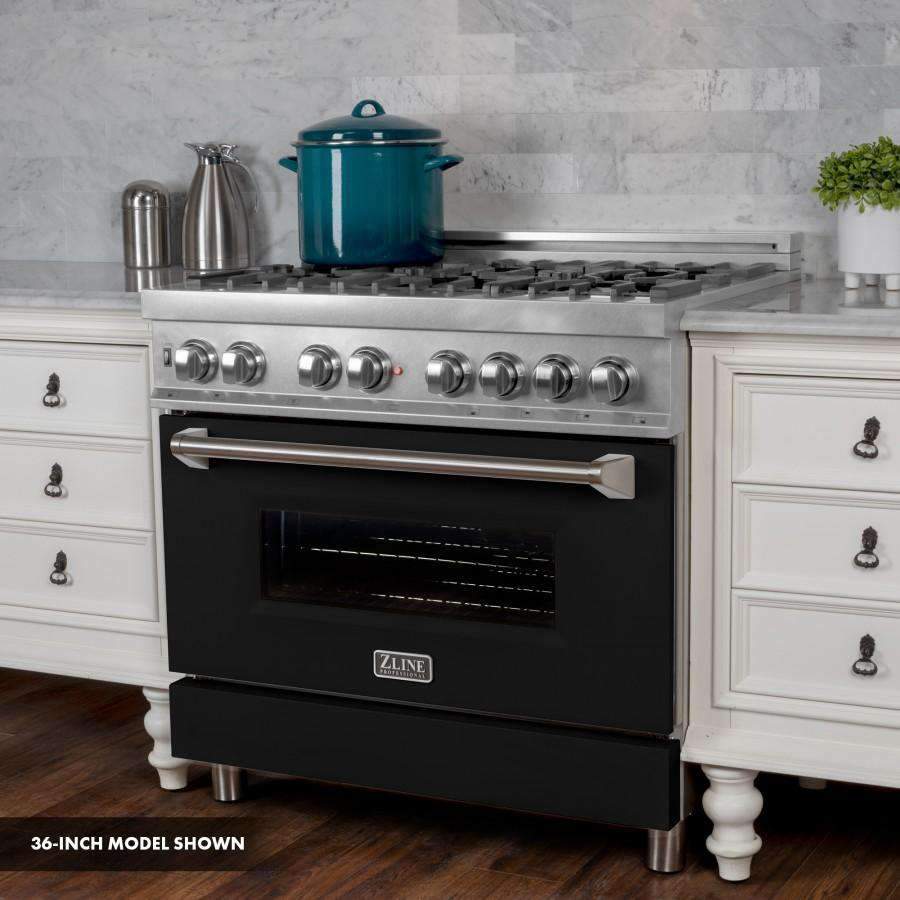 Close view of dual fuel range front with stainless control knobs and black oven door