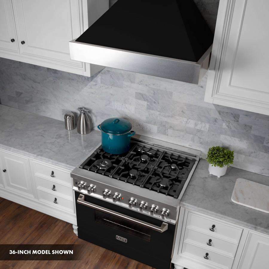 Dual fuel range in kitchen, stainless cooktop with burners and black oven door beneath