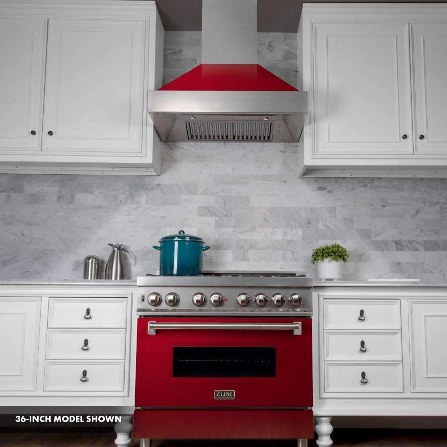 Dual fuel range in kitchen layout with satin hood, stainless cooktop, and red oven door