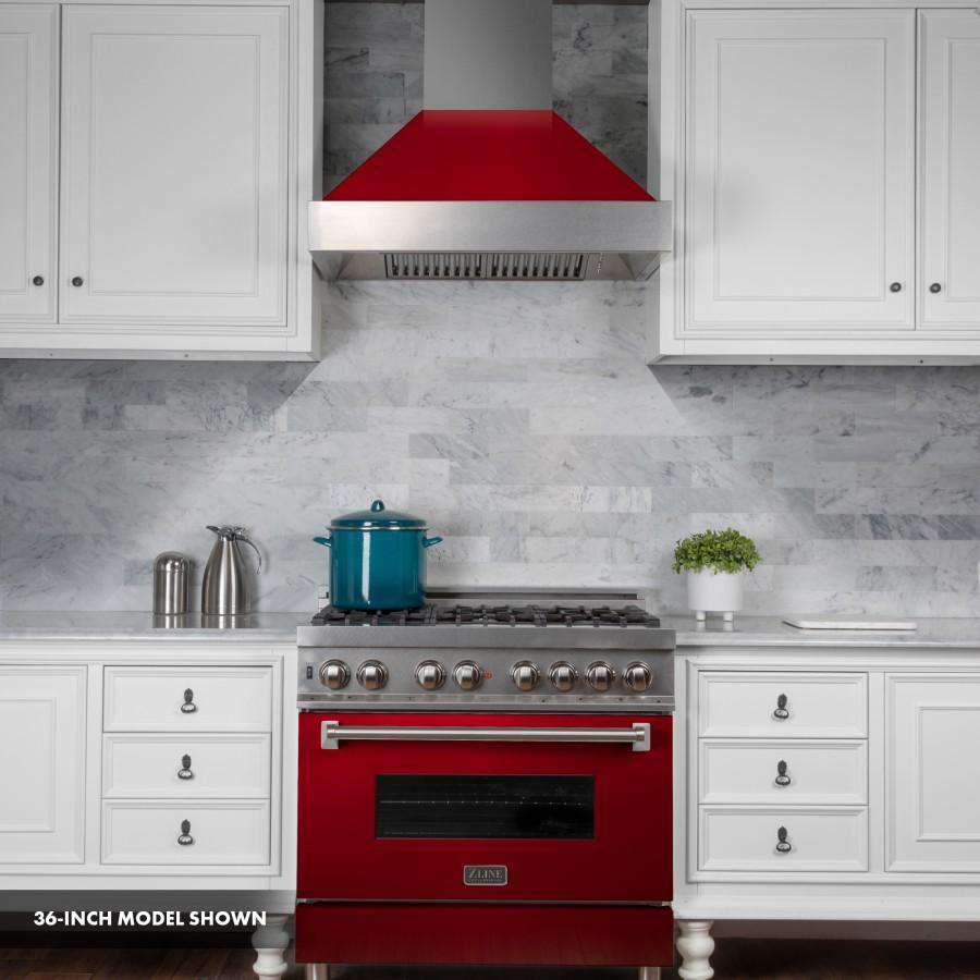 Dual fuel range with stainless cooktop, red oven door, and satin hood over burners