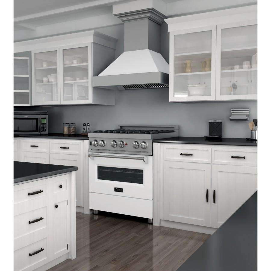 Dual fuel range with stainless cooktop grates, white matte oven door, and vent hood.