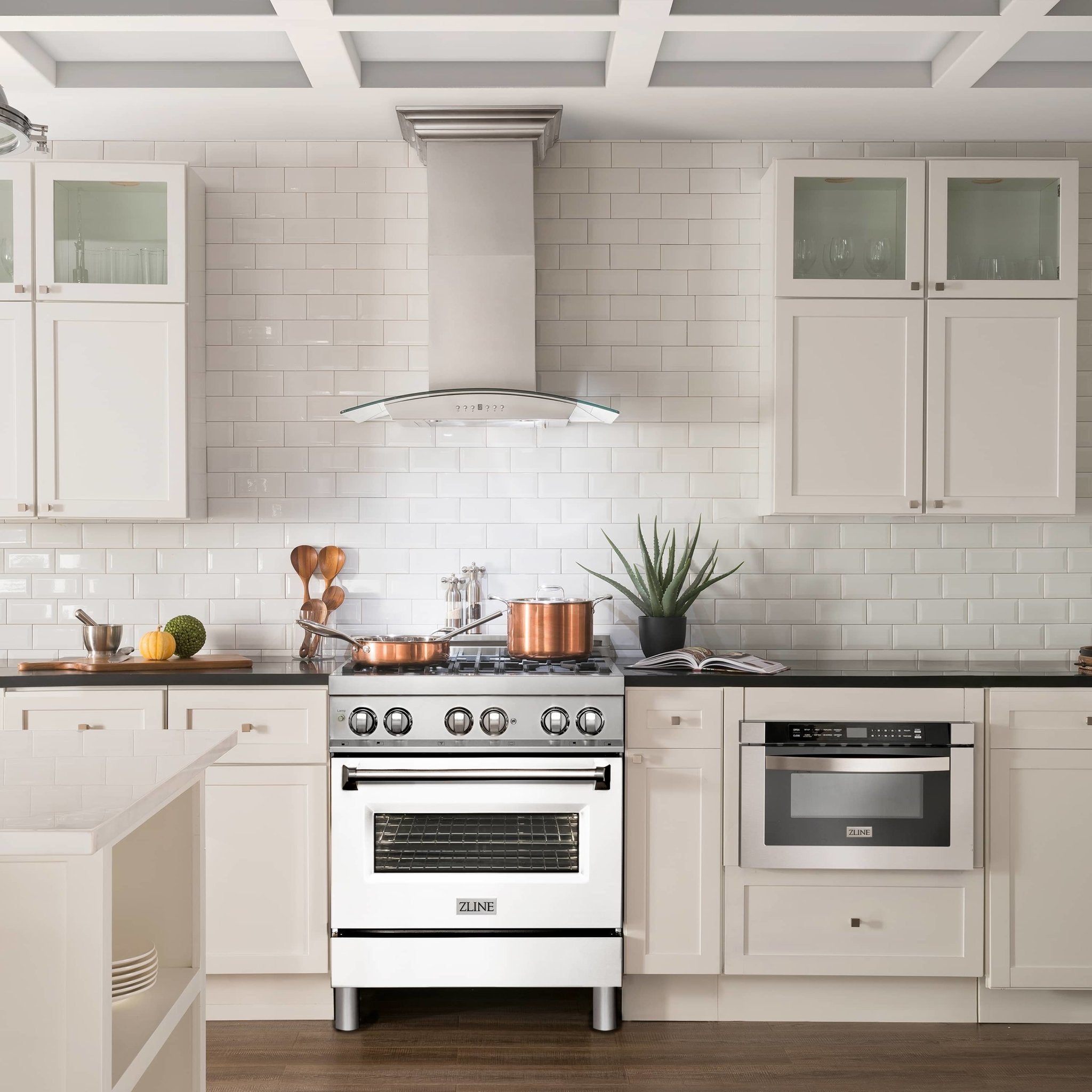 Freestanding dual fuel range in kitchen with black cooktop and white oven door