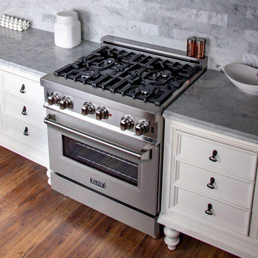 Stainless steel gas range with black burner grates, control knobs, and oven door