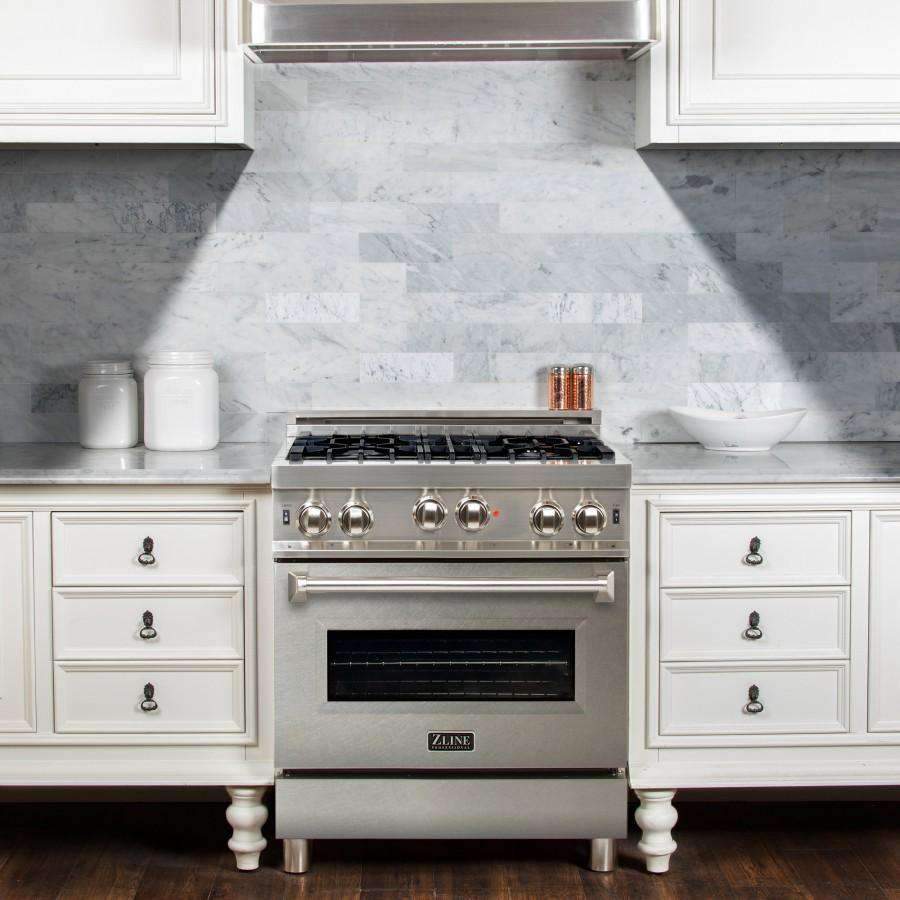 Stainless steel gas range with burner grates, control knobs, and oven door