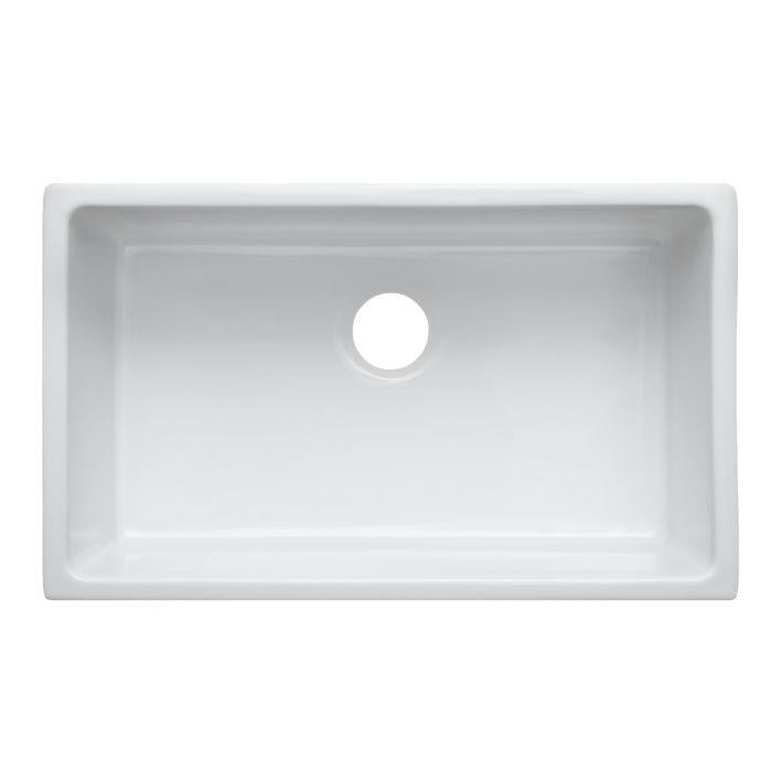 White fireclay single-bowl sink interior with drain hole at center back