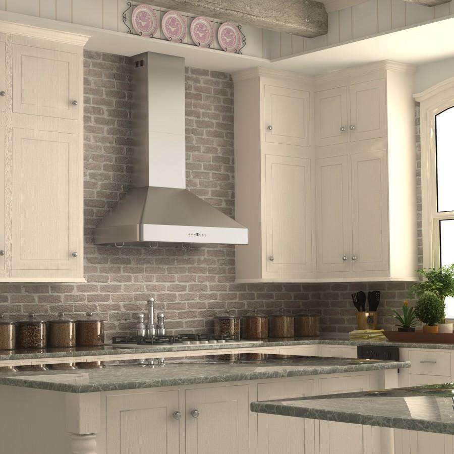 Stainless steel wall range hood over cooktop, integrated chimney and canopy