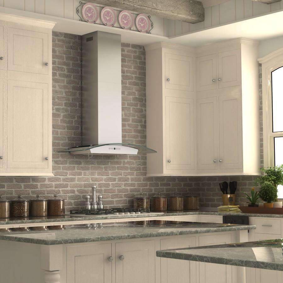 Stainless wall range hood with chimney above black gas burners