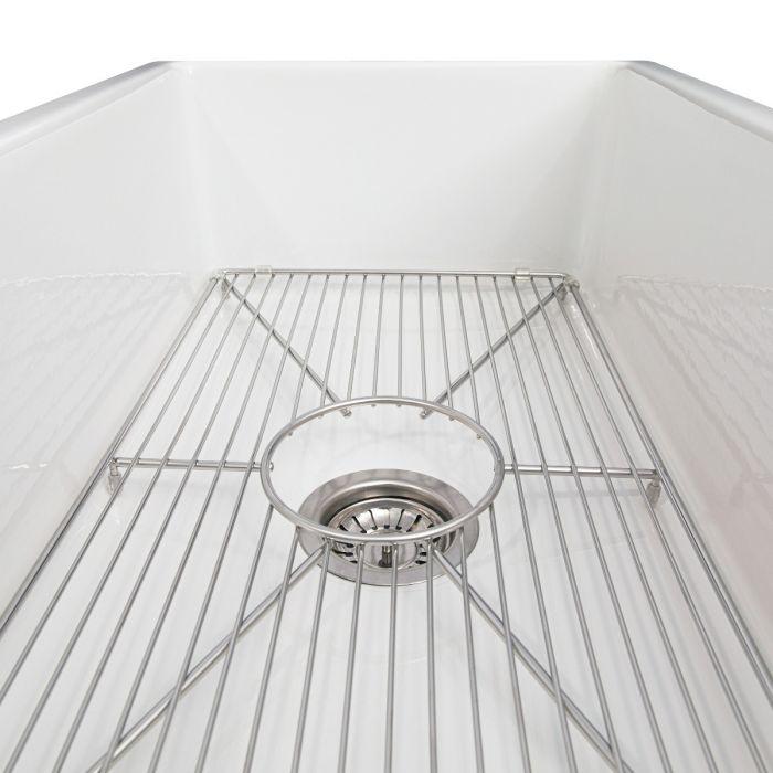 White sink basin with stainless wire bottom grid and drain strainer