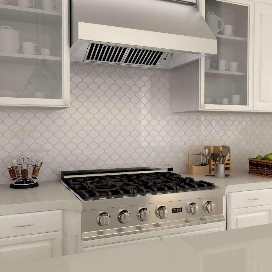 Under-cabinet range hood underside with vent grille over the gas cooktop
