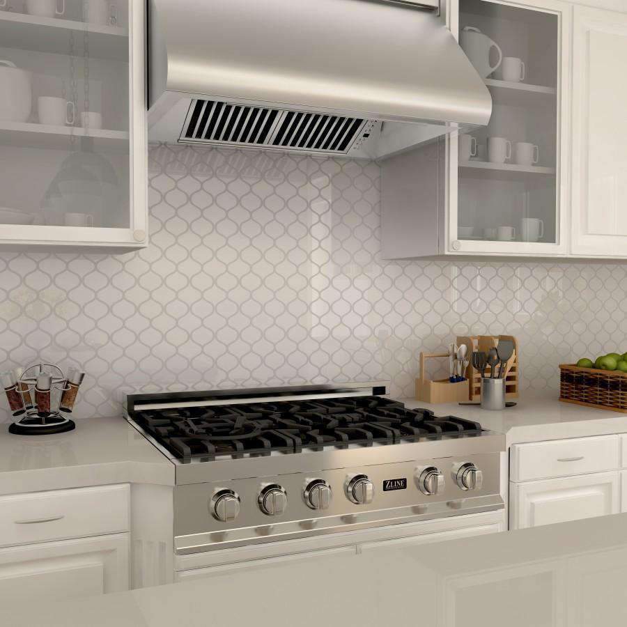 Stainless steel under-cabinet range hood with front controls above the stove