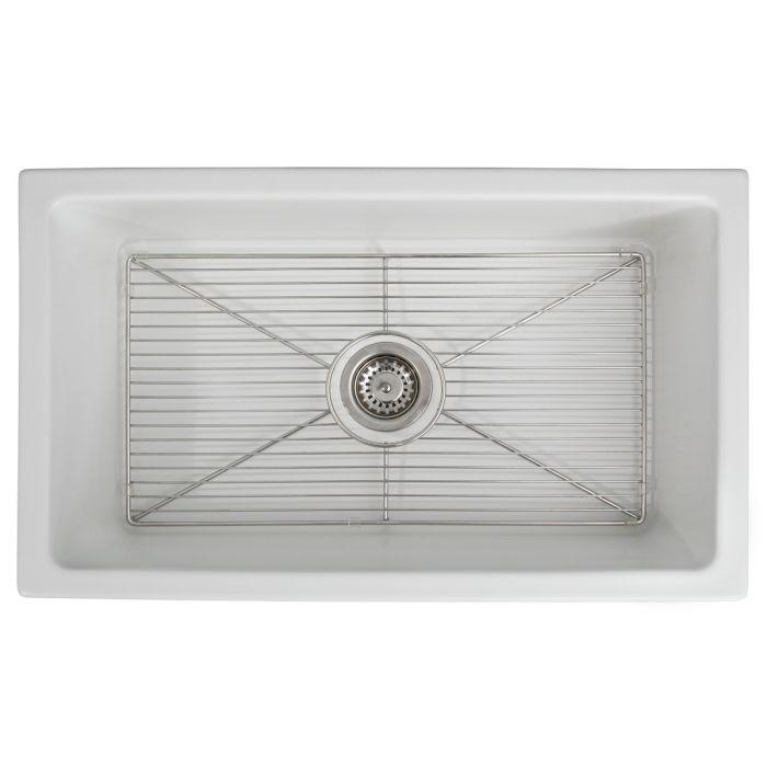 White matte fireclay kitchen sink with built-in bottom grid and round drain opening