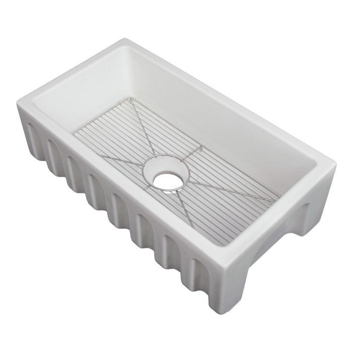 White matte apron-front fireclay kitchen sink with bottom rack grid and round drain opening