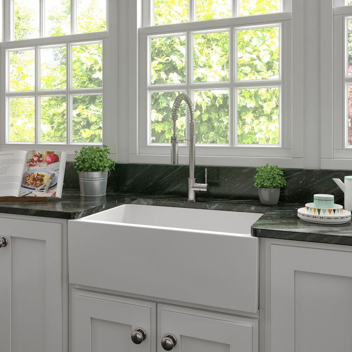 Farmhouse apron-front fireclay sink in white matte finish with ribbed basin front