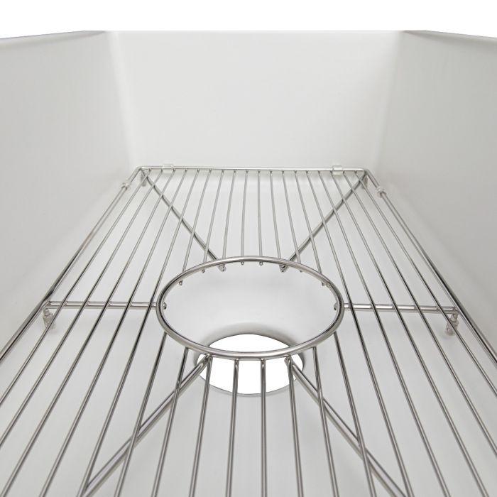 Single-bowl fireclay sink with installed stainless bottom grid and central drain