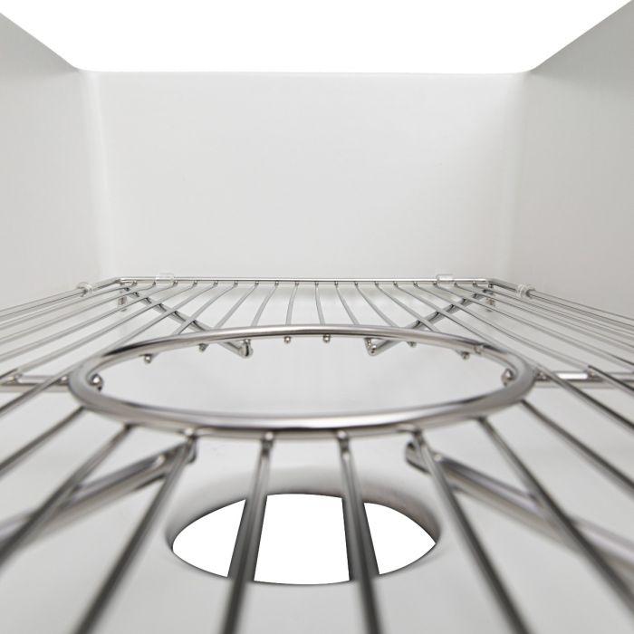 Bottom grid close-up with circular insert and curved support ribs inside sink