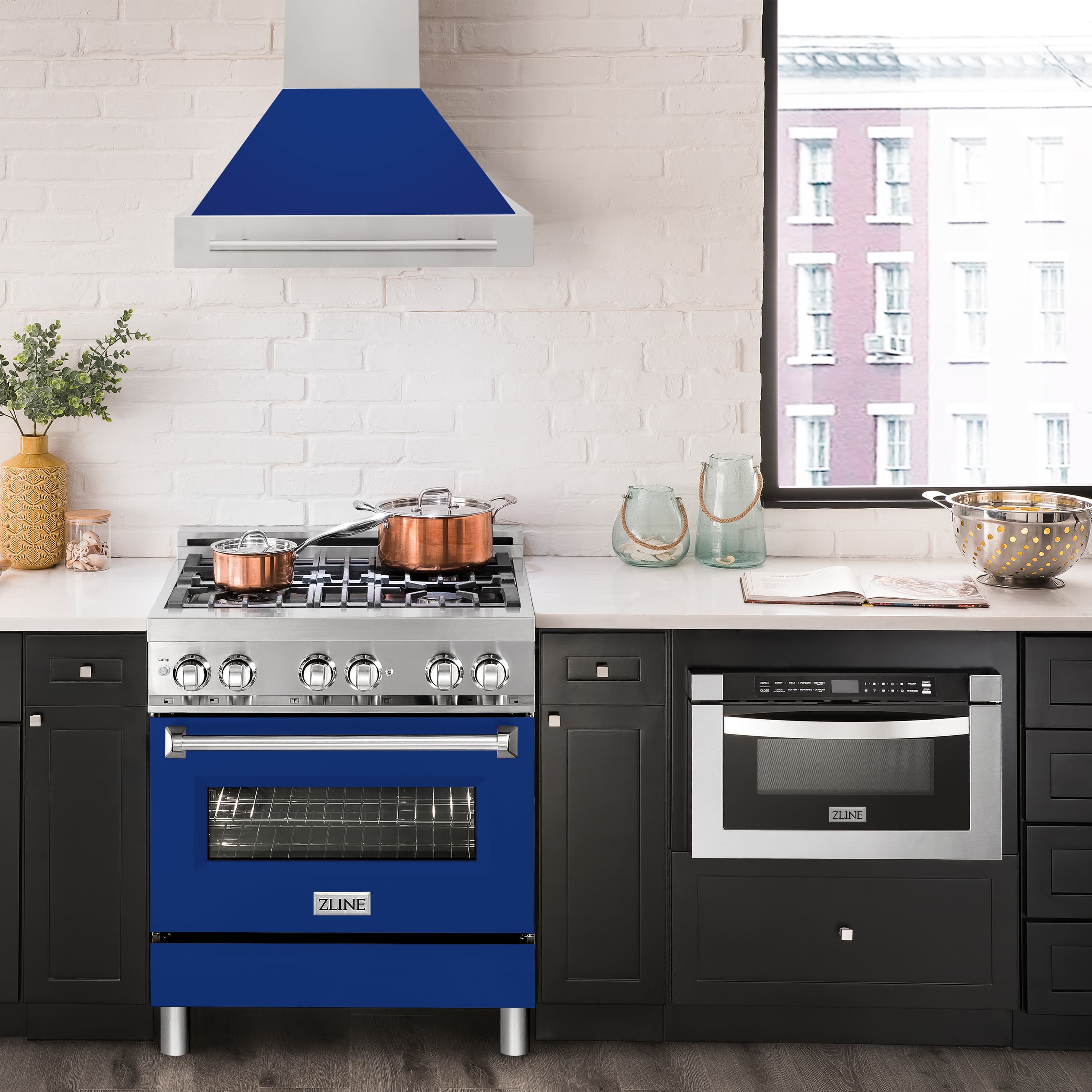 Stainless steel wall mount range hood with blue glossy shell above range controls
