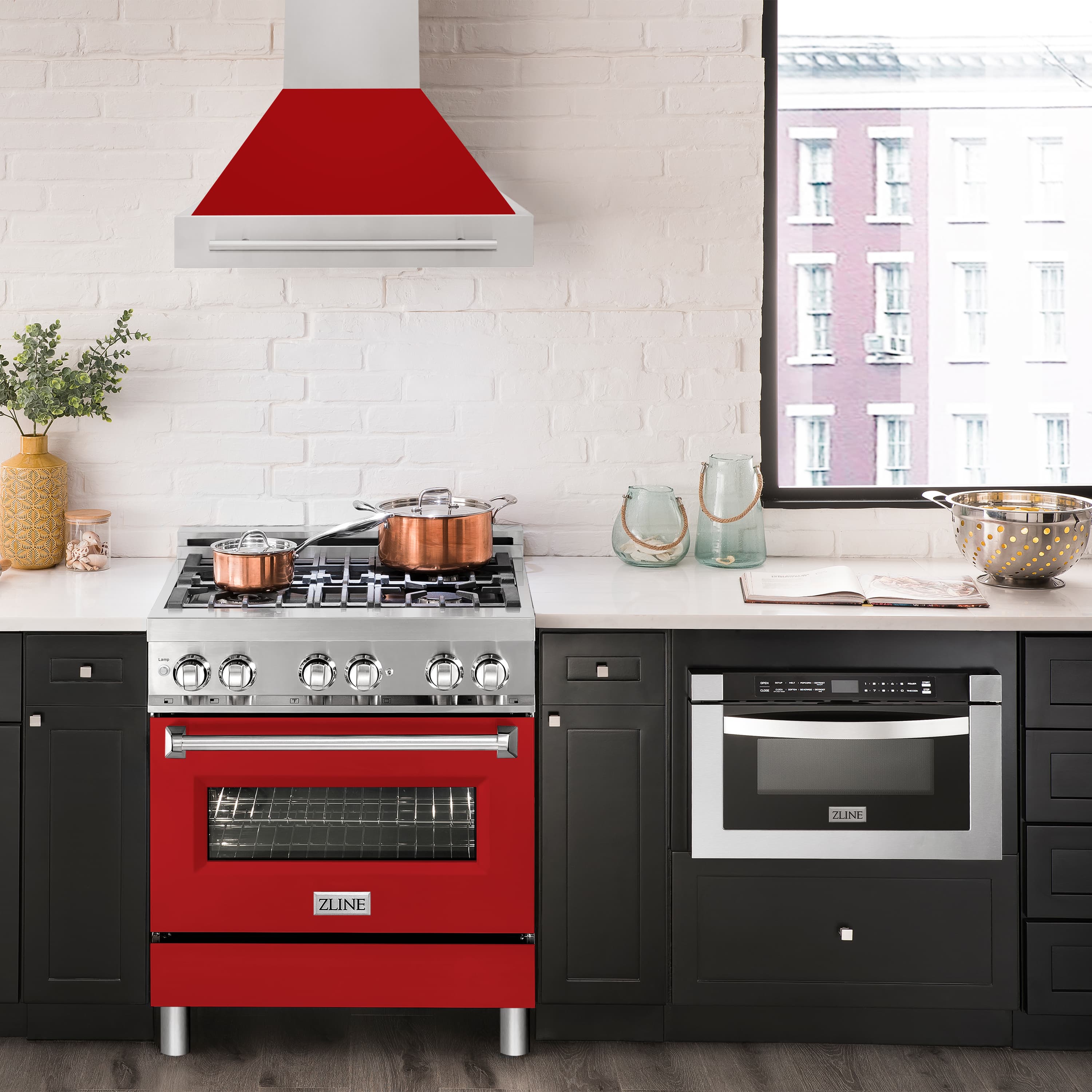 Wall mount range hood with red matte canopy and stainless chimney over a cooktop