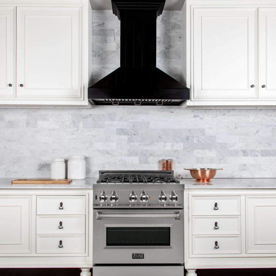 Black wooden range hood above a stainless gas cooktop