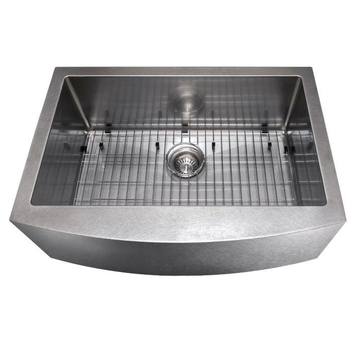 Single-bowl stainless apron sink with bottom grid and center drain close-up