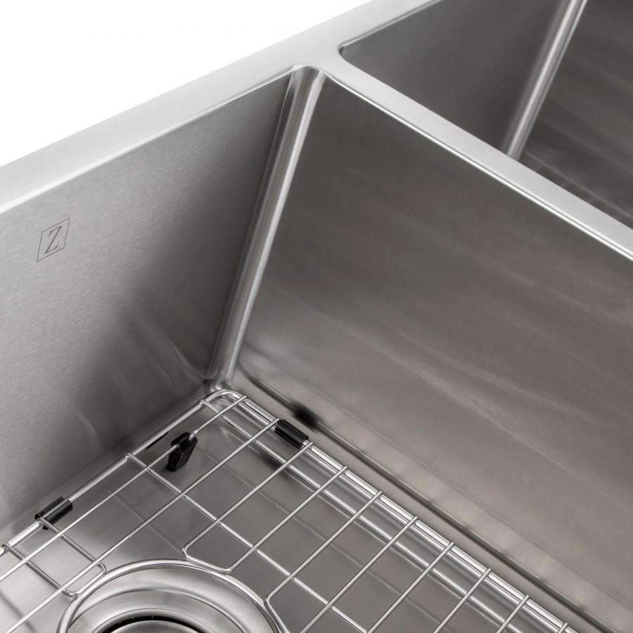 Stainless steel double-bowl sink with bottom grid, close-up of grid and divider