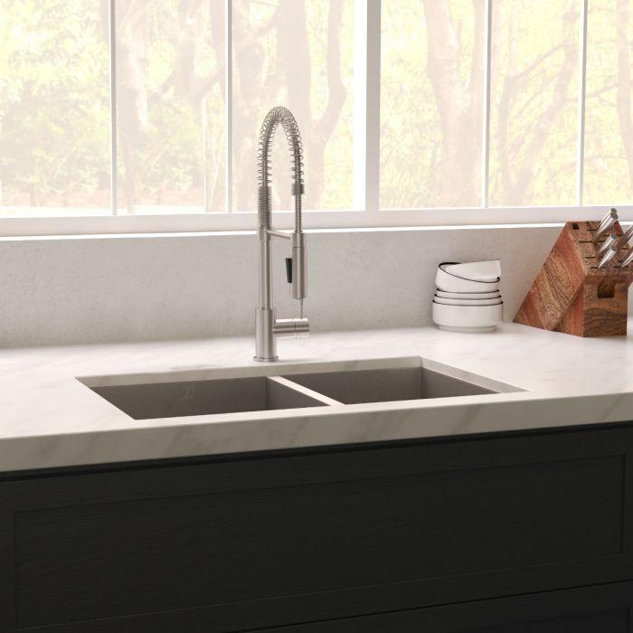 Installed double-bowl stainless steel sink with tall faucet and drain strainers