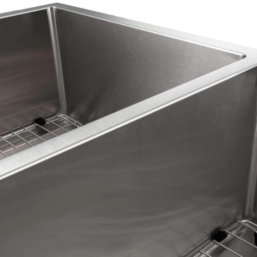 Stainless steel double-bowl sink interior with bottom rack and round drain strainer