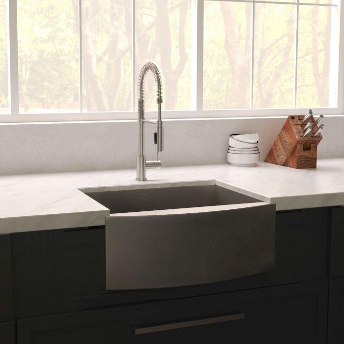 Apron-mount single-bowl stainless steel sink with tall faucet and countertop