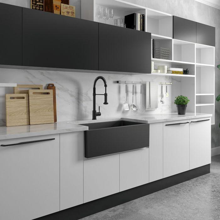 Charcoal apron front sink in modern kitchen layout with countertop and faucet